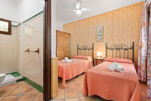 a room with two beds and a shower at Casa Rural Salrima in Alora +32 photos