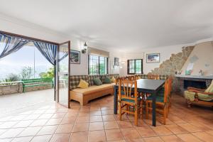 a living room with a table and a couch at Casa Rural Salrima in Alora