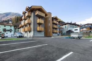 a building with balconies on the side of a parking lot at Palazzo Righi in Carisolo