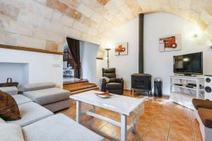 a living room with a couch and a table at Es Figueral in Campos