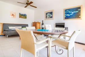 a dining room and living room with a table and chairs at Puerto Rico Apt. Port de Sóller in Port de Soller
