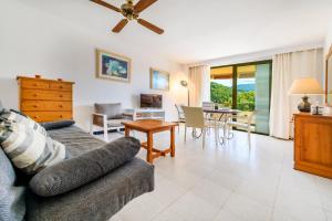 a living room with a couch and a table at Puerto Rico Apt. Port de Sóller in Port de Soller