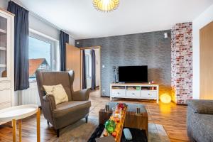 a living room with a couch and a tv at Ferienwohnung Apfelkorb in Jork