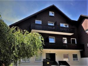 a large black house with a balcony at Harzperle Wohnung Nr 6 in Braunlage