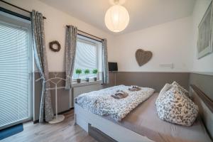 a bedroom with a bed and a window at Harzperle Wohnung Nr 6 in Braunlage