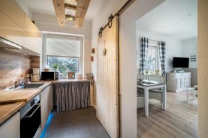 a kitchen with a sink and a desk in a room at Harzperle Wohnung Nr 6 in Braunlage