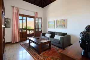 a living room with a couch and a coffee table at Finca Remedios in Los Valles