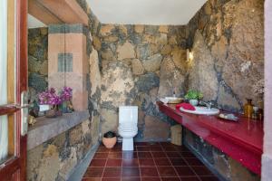 a stone bathroom with a toilet and a sink at Finca Remedios in Los Valles +19 photos