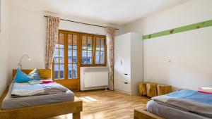 a bedroom with two beds and a window at Schlegelhansenhof in Buchenbach +74 photos