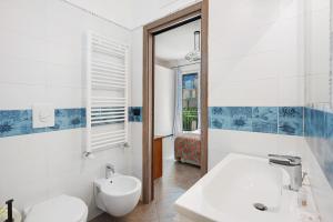 a bathroom with a sink and a toilet and a mirror at Ce Tour - Cetara Guest House in Cetara