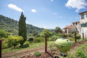 a green pot on the side of a fence at Modern Heritage House in Imperia