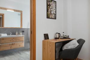 a room with a desk and a chair next to a sink at La Douce Pomme in Saint-Pierre +58 photos