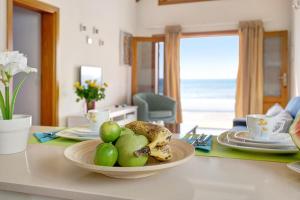 a table with a bowl of fruit on top of it at Casita Martina in Punta Mujeres