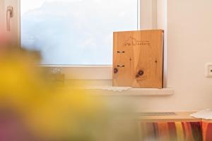 a mirror on a wall next to a window at Ferienwohnung Jakob in Schwendau