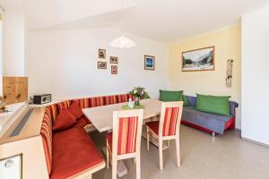a living room with a table and a couch at Ferienwohnung Jakob in Schwendau