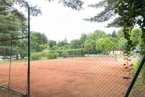 a tennis court with a net on a court at Nice Lake view apartment in Ispra