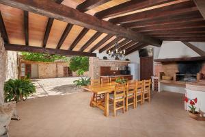 an outdoor patio with a wooden table and chairs at Son Soler - Can Torres in Islas Baleares