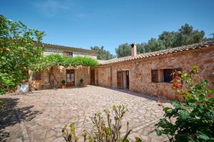 an external view of a house with a stone courtyard at Son Soler - Can Torres in Islas Baleares