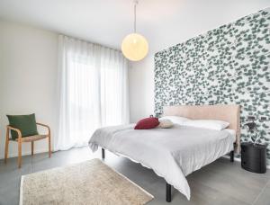 a bedroom with a bed with a floral accent wall at Villa Angelina in Lazise +27 photos