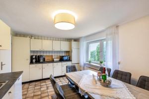 a kitchen and dining room with a table and chairs at Haus im Igelweg in Bad Münstereifel