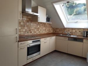 a kitchen with white appliances and a window at Ferienwohnung am Geißberg in Kleines Wiesental
