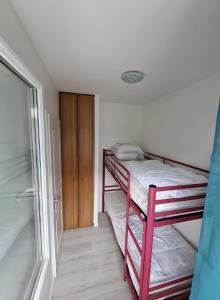 a small bedroom with a bunk bed and a closet at Appartement paisible Richelieu in Chaveignes +2 photos