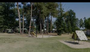 a park with a playground with a tent and a slide at Appartement paisible Richelieu in Chaveignes