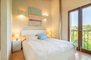 a bedroom with a bed and a large window at Redonda 1 in Costitx +19 photos