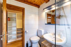 a bathroom with a toilet and a sink at La Casa Holzwiesen in Starzach +23 photos