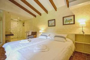 a bedroom with a large white bed with two pillows at Sestadors in La Puebla