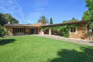 an exterior view of a house with a yard at Sestadors in La Puebla