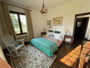 a bedroom with a bed and a chair and a window at Villa Giacinti in Padova +27 photos