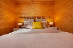 a bedroom with a large bed with wooden walls at La Cabañita de Javi in Tuineje