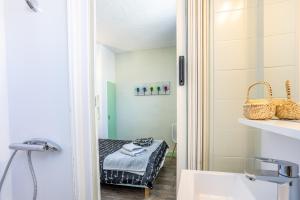 a small bathroom with a bed in a room at Chambres Espace Rennaissance in Chantonnay +102 photos