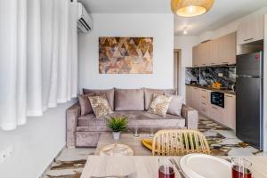 a living room with a couch and a table at Oceanida Thalia Lyxury Suite in Nikiana