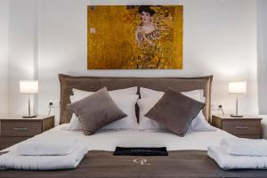 a bedroom with a bed with pillows and a painting at Oceanida Thalia Lyxury Suite in Nikiana +17 photos
