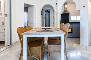 a dining room with a table and chairs at Casa Feliz in Mijas
