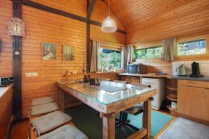 a kitchen with a table in the middle of a room at Haus 7 Bernau in Bernau im Schwarzwald