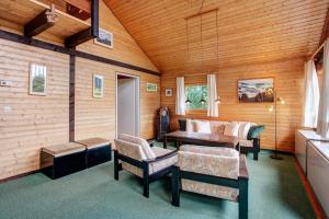 a living room with a couch and a table and chairs at Haus 7 Bernau in Bernau im Schwarzwald