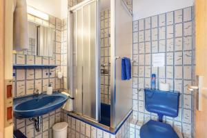 a bathroom with a blue toilet and a sink at Pension Alte Gerbe in Außerurberg +35 photos