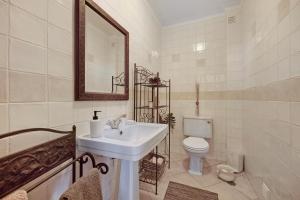 a white bathroom with a sink and a toilet at Villa Ramos in Lagos +20 photos