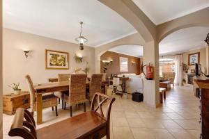 a dining room and living room with a table and chairs at Villa Ramos in Lagos