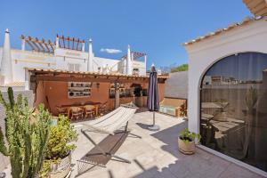a patio with a hammock and a house at Villa Ramos in Lagos