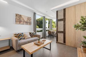 a living room with a couch and a table at Manuela's whim in Málaga