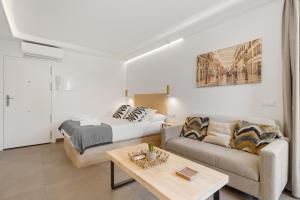 a living room with a bed and a couch at Manuela's whim in Málaga