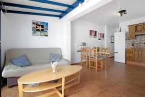 a living room with a couch and a table at Vista al Mar, La Graciosa in Caleta de Sebo +16 photos