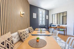 a living room with two tables and a couch at Chambres Espace Rennaissance in Chantonnay