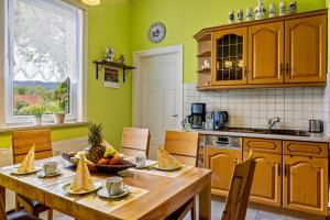 a kitchen with a wooden table with fruit on it at Ferienwohnung Burgblick in Plaue