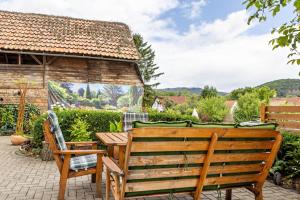 a patio with a wooden table and chairs at Ferienwohnung Burgblick in Plaue
