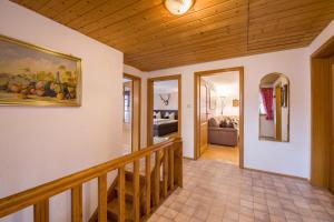 a staircase in a house with a painting on the wall at Ferienhaus Annelies in Übersee +27 photos
